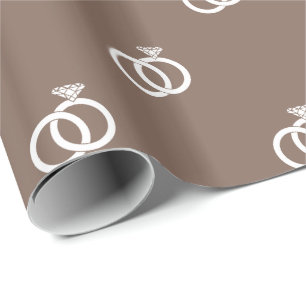 White Wedding Rings on Taupe Brown Wrapping Paper