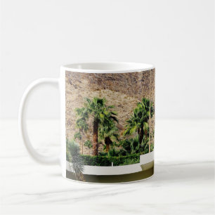 WHITE WOODEN FENCE NEAR GREEN PALM TREE DURING DAY COFFEE MUG
