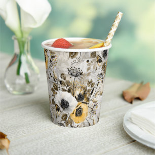 White, yellow anemones on a grey-brown background. paper cups