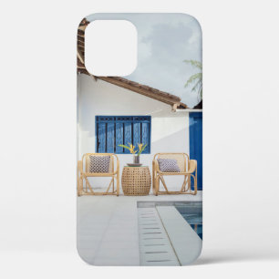 Wicker table and two chairs near swimming pool iPhone 12 case