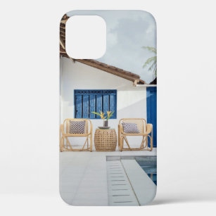 Wicker table and two chairs near swimming pool iPhone 12 case