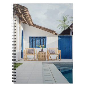 Wicker table and two chairs near swimming pool notebook