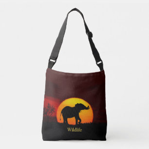 Wild elephant & sunrise on the jungle crossbody bag