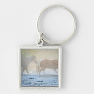 Wild horses running through water key ring