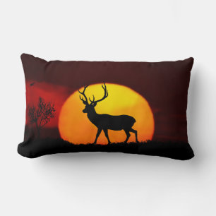 Wild reindeer silhouette & sunrise on a jungle lumbar cushion
