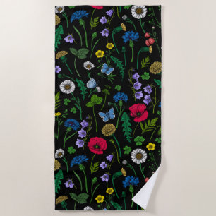 Wildflowers on black beach towel