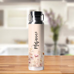 Wildflowers peach beige custom name script water bottle<br><div class="desc">A peach coloured background. Decorated with wildflowers in beige,  cream and pink.  Personalise and add your name.  Black handwritten style script.</div>