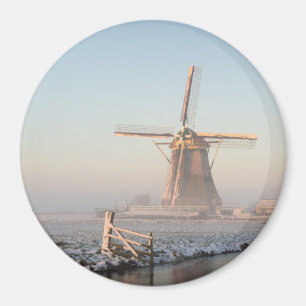 Windmill in the snow at sunrise round magnet
