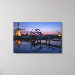 Windmills and a drawbridge at sunset canvas print