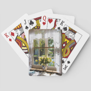 Window with lace curtain and tulips playing cards