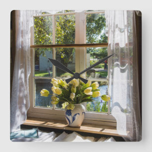 Window with lace curtain and tulips square wall clock