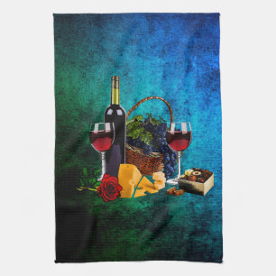 Wine glasses, bottle, grapes, cheese, chocolates tea towel