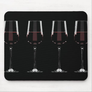 Wine glasses with red wine on black mouse pad