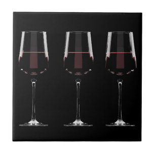 Wine glasses with red wine on black tile