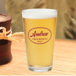 Wine Red Stylised Wedding Groomsman Glass<br><div class="desc">Beer glass for the wedding groomsman that features his name printed in a trendy, wine red colour, stylised script inside a wine red colour oval border along with wedding year date. A great party supply idea for a bachelor party! Personalise your beer glass by editing and replacing name and date...</div>