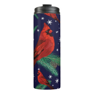 Winter birds - cardinals on fir-tree branches with thermal tumbler