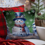 Winter Forest Snowman Christmas | Green<br><div class="desc">Bring joy and whimsy to your seasonal decor with this charming Green Winter Forest Holiday Throw Pillow. Featuring a smiling snowman dressed in a classic top hat and cosy scarf, the design captures the magic of a wintry scene with softly falling snow and delicate white snowflakes. Nestled among frosted trees,...</div>