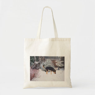 Winter snow scene with cute black and tan dog tote bag