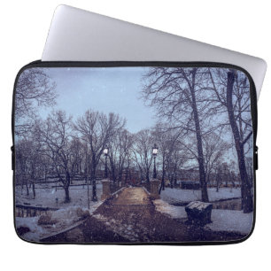 Winter snowy city park in the evening laptop sleeve