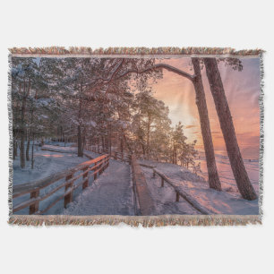 Winter sunset in pine forest near sea throw blanket