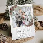 Winter Watercolor Pine Christmas Wedding Photo Save The Date<br><div class="desc">This elegant winter-themed wedding save the date card features a photo template with a thin faux gold frame, decorated with corner bouquets of watercolor greenery, pine cones and winter evergreen branches, accented with burgundy red holly berries. The “Save the Date” text is in trendy modern handwriting script, and the on...</div>