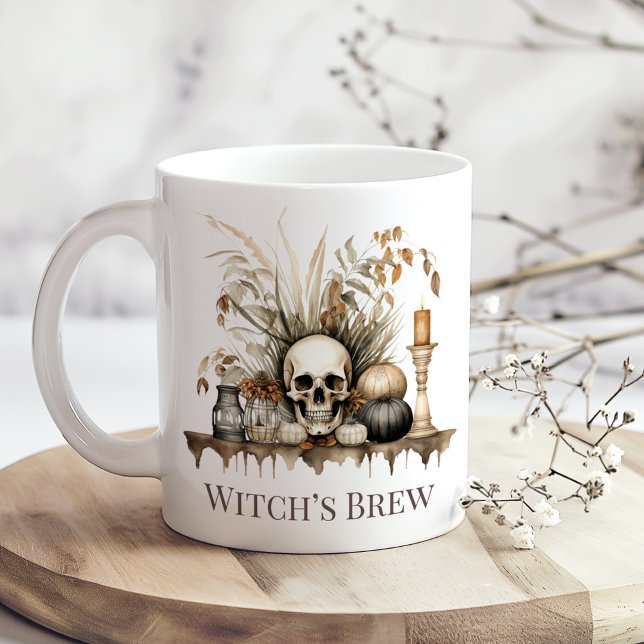 Witch’s Brew Mug – Autumn Skull and Candles Design (Witch’s Brew Mug – Autumn Skull and Candles Design on a boho table with tiny dry flowers.)