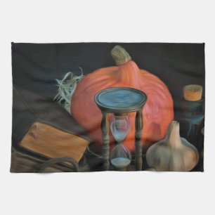 Witchery objects on a table in a dark room tea towel