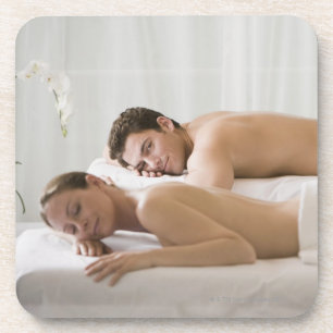 woman and man lying on massage benches coaster