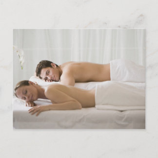 woman and man lying on massage benches postcard