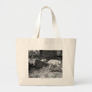 Woman bottle feeding an antelope. large tote bag