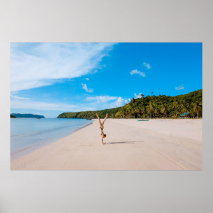 Woman doing acrobatic on seashore near mountain ra poster