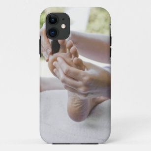 Woman getting foot massage with hot stone iPhone 11 case