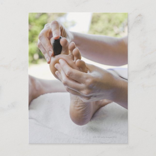 Woman getting foot massage with hot stone postcard (Front)