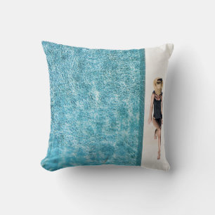 Woman in black bikini bottom and white sun hat sta cushion