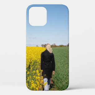 Woman in black coat standing on green grass field  iPhone 12 case