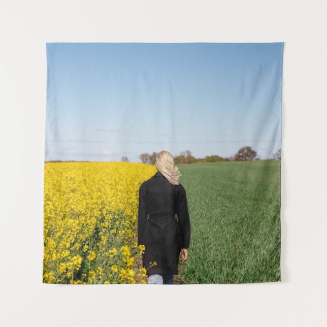 Woman in black coat standing on green grass field  tapestry (Front)