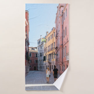 Woman in black jacket walking on sidewalk in the m bath towel