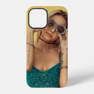 Woman in blue bralette holding sunglasses putting iPhone 12 case