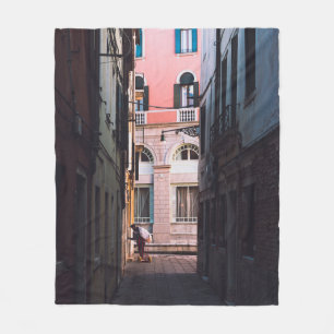 WOMAN IN WHITE SHIRT AND BLACK PANTS WALKING ON SI FLEECE BLANKET