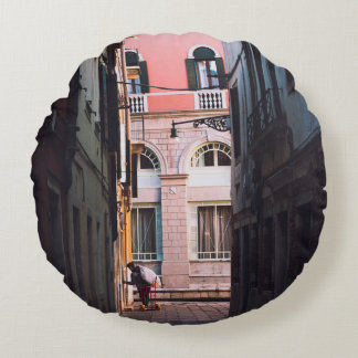 WOMAN IN WHITE SHIRT AND BLACK PANTS WALKING ON SI ROUND CUSHION