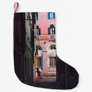 WOMAN IN WHITE SHIRT AND BLACK PANTS WALKING ON SI SMALL CHRISTMAS STOCKING