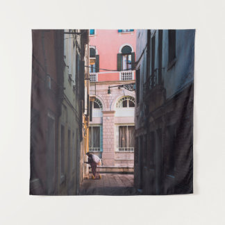 WOMAN IN WHITE SHIRT AND BLACK PANTS WALKING ON SI TAPESTRY