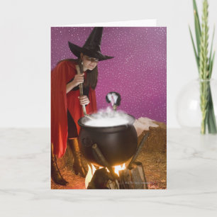 Woman in witch costume stirring cauldron card
