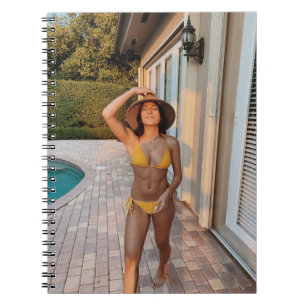 Woman in yellow bikini standing on brown brick flo notebook