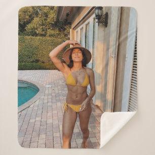 Woman in yellow bikini standing on brown brick flo sherpa blanket