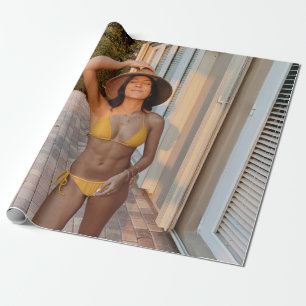 Woman in yellow bikini standing on brown brick flo wrapping paper