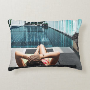 Woman laying on brown chaise lounge decorative cushion