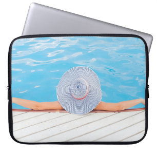 Woman leaning on white concrete surface beside swi laptop sleeve