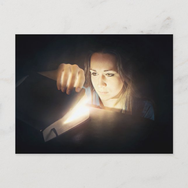 Woman Looks Inside a Glowing Book Postcard (Front)