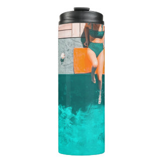 Woman lying beside swimming pool in the morning thermal tumbler